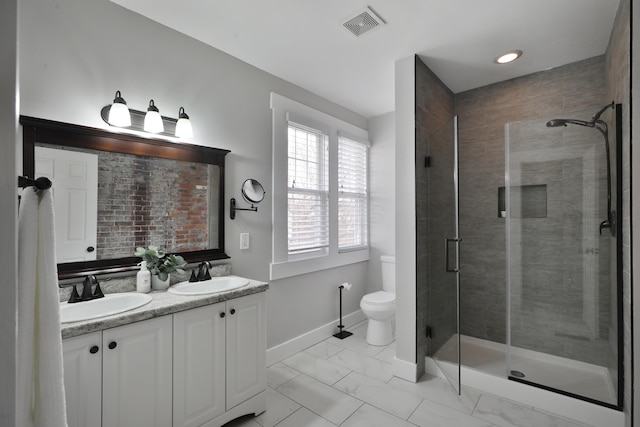 full bathroom featuring marble finish floor, visible vents, a sink, and a shower stall