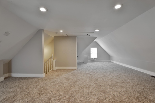 bonus room featuring carpet, attic access, baseboards, and vaulted ceiling