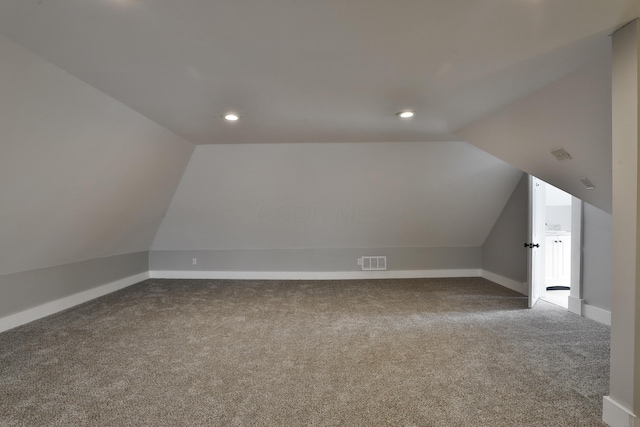 additional living space featuring vaulted ceiling, carpet flooring, visible vents, and recessed lighting