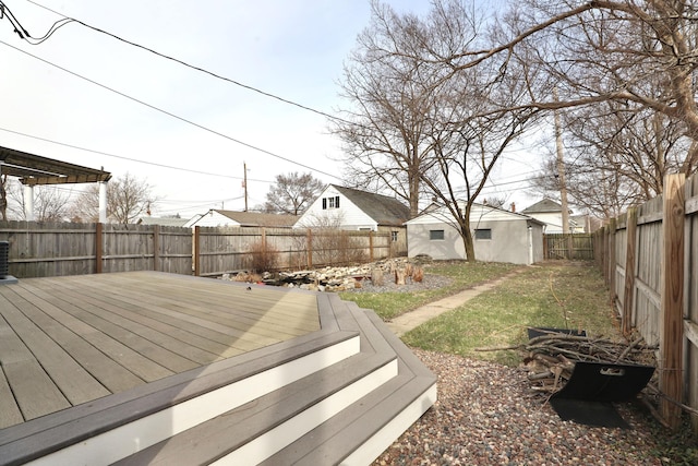 deck featuring an outdoor structure and a fenced backyard