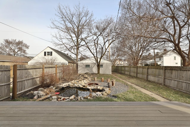 view of yard with a fenced backyard and an outbuilding