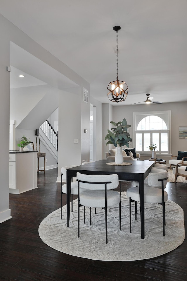 dining room with stairway, dark wood finished floors, visible vents, and baseboards