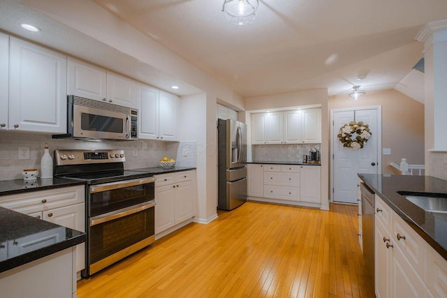 kitchen featuring light wood-type flooring, stainless steel appliances, and white cabinetry