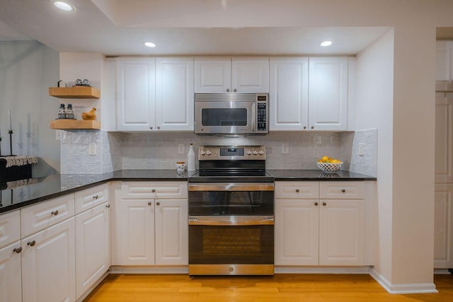 kitchen with light wood-type flooring, recessed lighting, appliances with stainless steel finishes, white cabinets, and open shelves