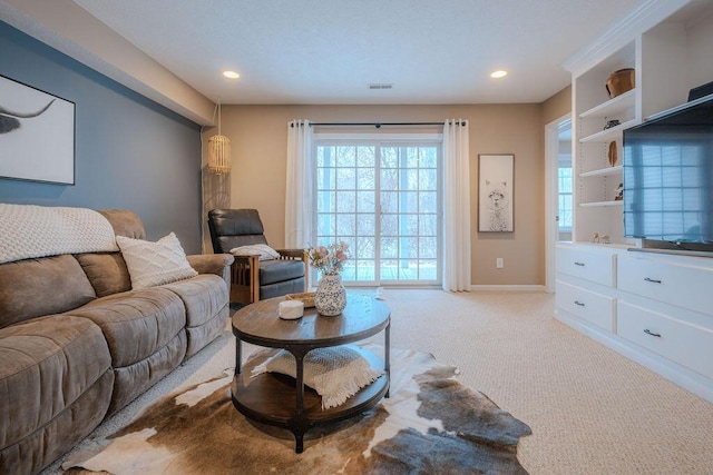 living area featuring recessed lighting, visible vents, baseboards, and light colored carpet