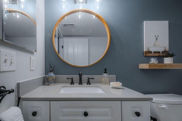 bathroom with visible vents and vanity