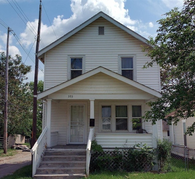 view of front of house with a porch and fence