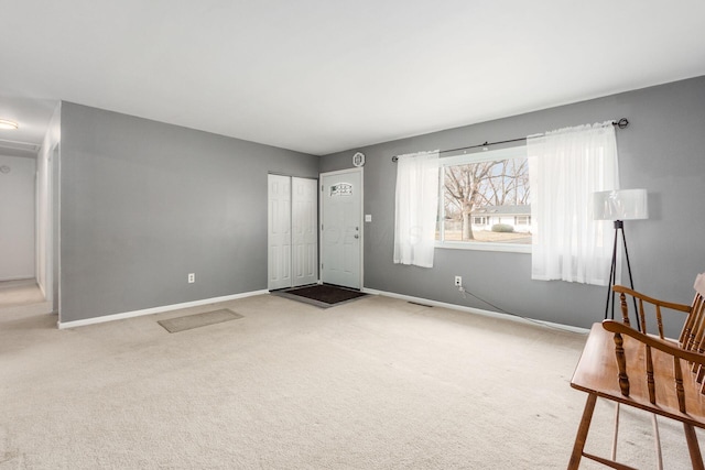 unfurnished room featuring carpet, visible vents, and baseboards