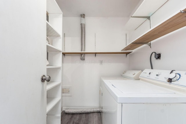 laundry room featuring laundry area, wood finished floors, and washer and dryer