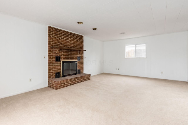 unfurnished living room with a brick fireplace and carpet