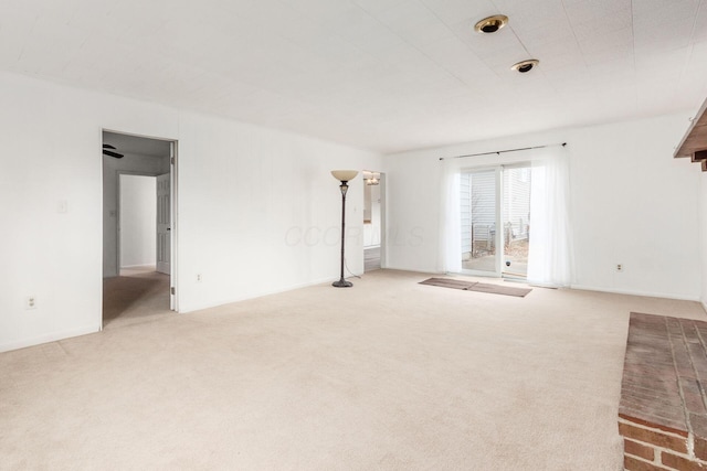 unfurnished living room with carpet and baseboards