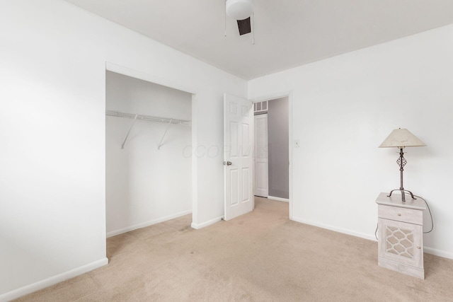 unfurnished bedroom featuring carpet floors, a closet, visible vents, and baseboards