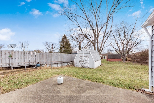 view of yard featuring an outbuilding, a fenced backyard, a patio, and a storage shed