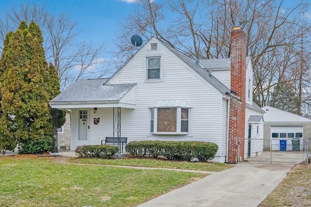 view of front of property featuring a porch, a shingled roof, an outdoor structure, a chimney, and a front yard