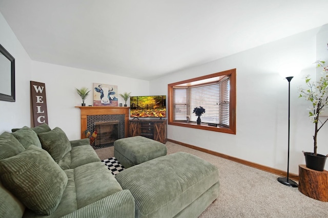 carpeted living room with a fireplace and baseboards