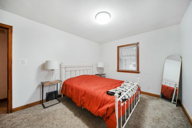 carpeted bedroom featuring baseboards