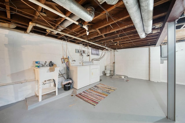 unfinished basement with a sink and washer and dryer