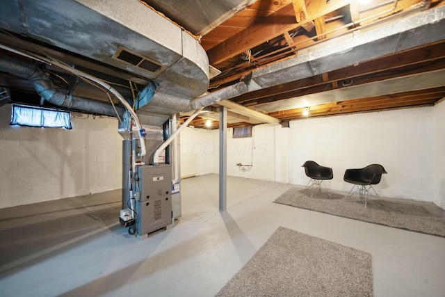 basement with visible vents and heating unit