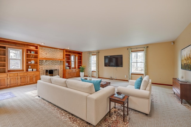 living room with built in features, light carpet, a fireplace, and baseboards