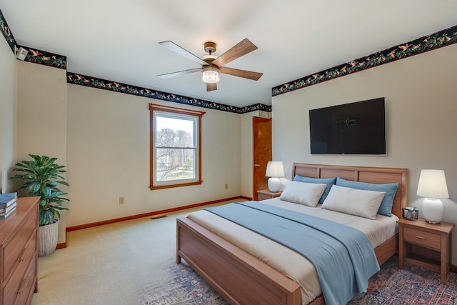 bedroom with a ceiling fan, carpet flooring, visible vents, and baseboards