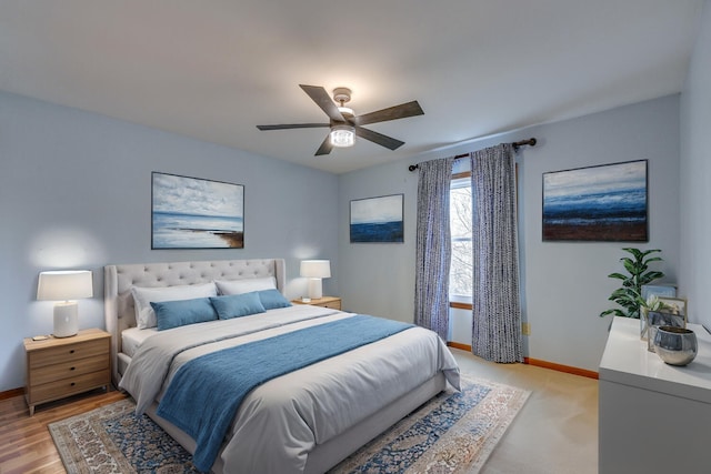 bedroom with ceiling fan and baseboards