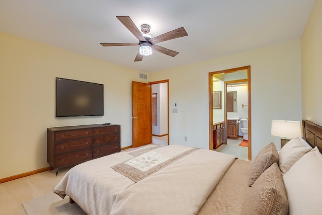 bedroom with light carpet, baseboards, visible vents, connected bathroom, and ceiling fan