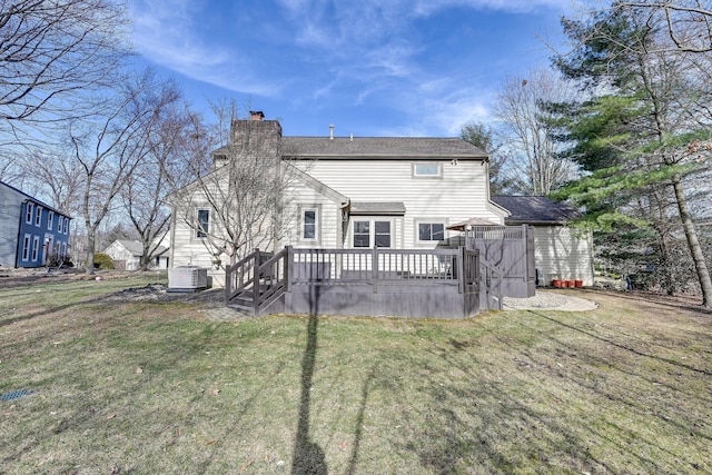 rear view of property with a deck, central AC, a yard, and a chimney