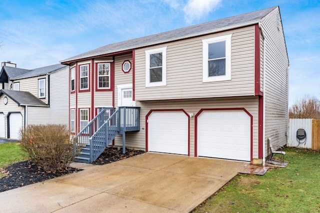 split foyer home with a garage and concrete driveway