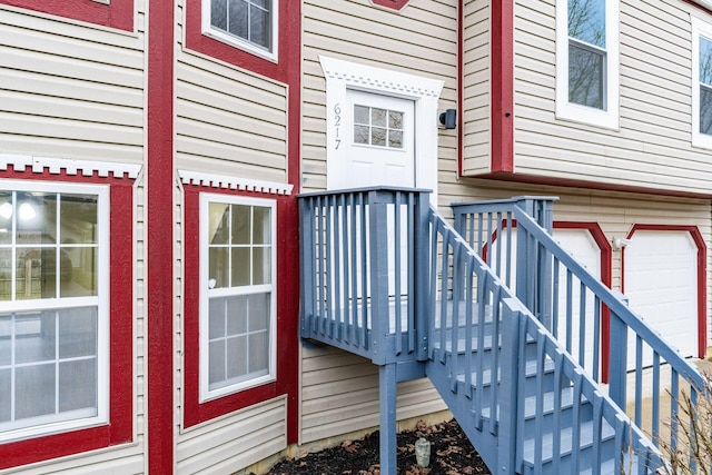 doorway to property with a garage