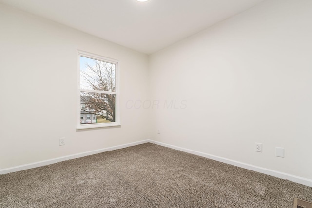 carpeted empty room with visible vents and baseboards