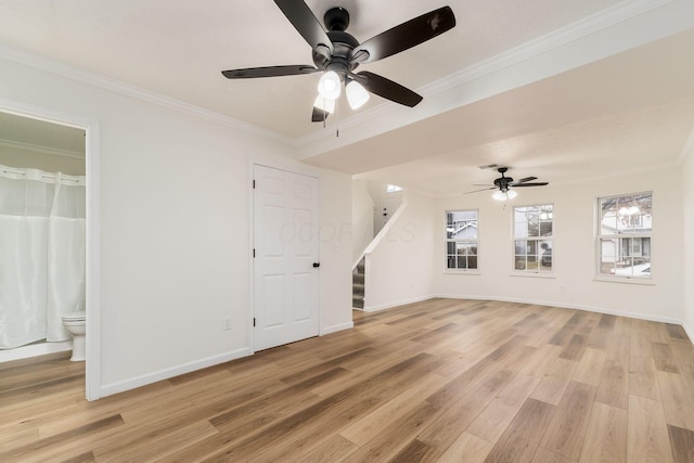 unfurnished living room featuring stairway, crown molding, light wood-style flooring, and baseboards