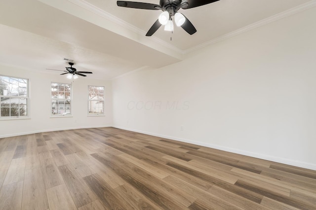 empty room with light wood finished floors, ceiling fan, ornamental molding, and baseboards