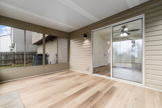 unfurnished sunroom featuring ceiling fan