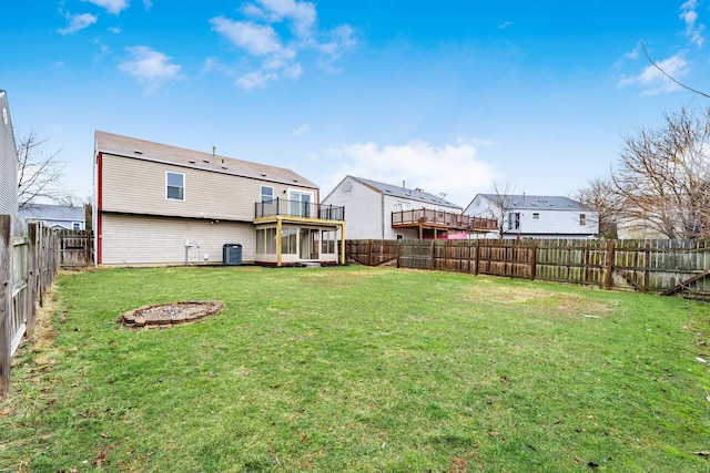 view of yard with central AC and a fenced backyard