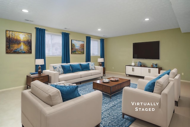 living room with recessed lighting, a wealth of natural light, and baseboards