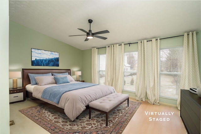 bedroom with wood finished floors, vaulted ceiling, and ceiling fan