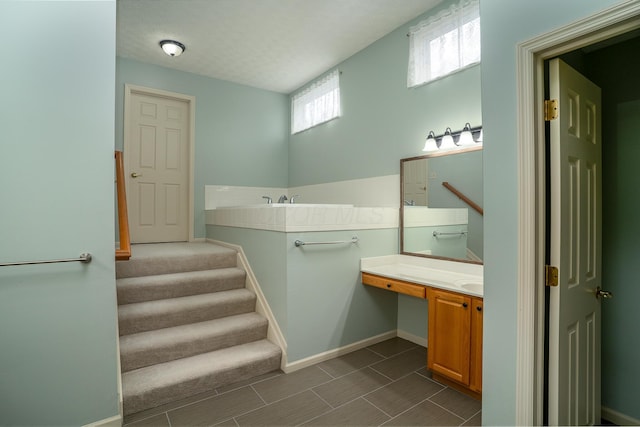 bathroom with baseboards and vanity