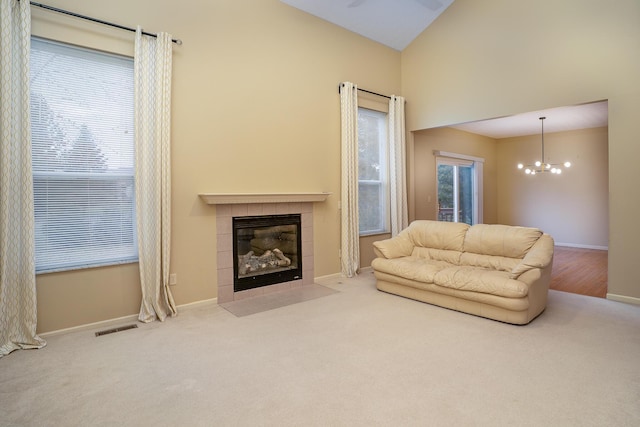 living area with carpet, visible vents, baseboards, and a tile fireplace