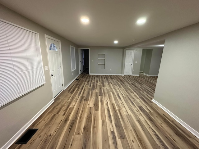 interior space featuring recessed lighting, wood finished floors, visible vents, and baseboards