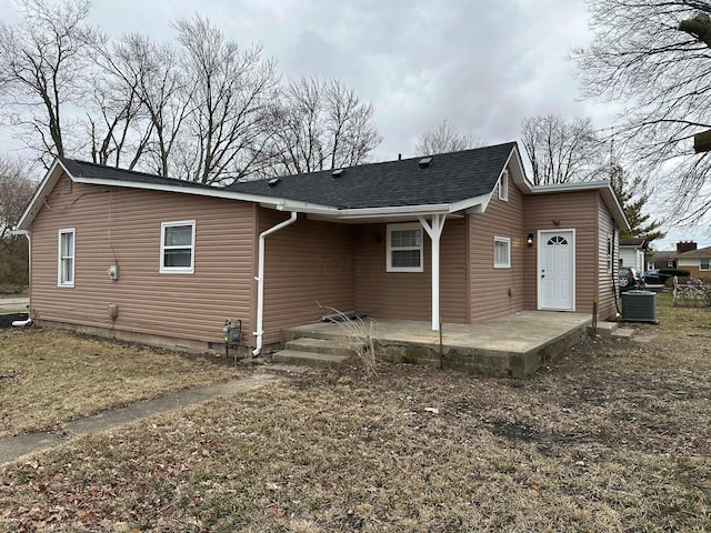 back of property with crawl space, roof with shingles, a patio area, and central air condition unit