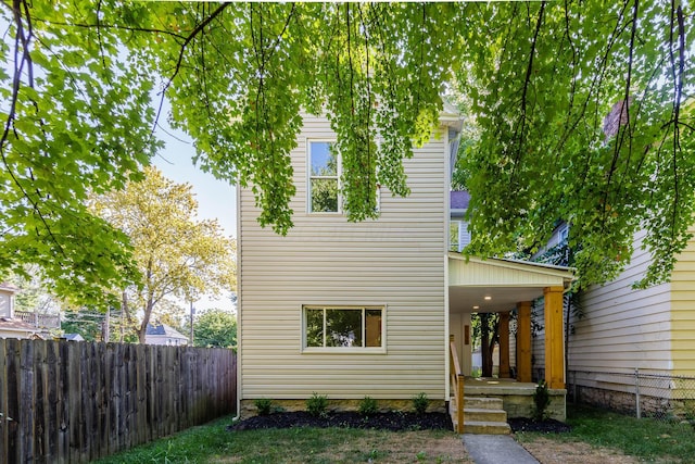 view of front of house featuring fence