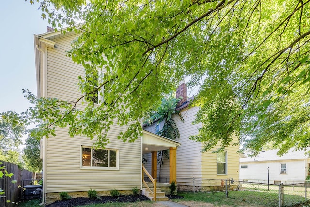 rear view of property featuring fence