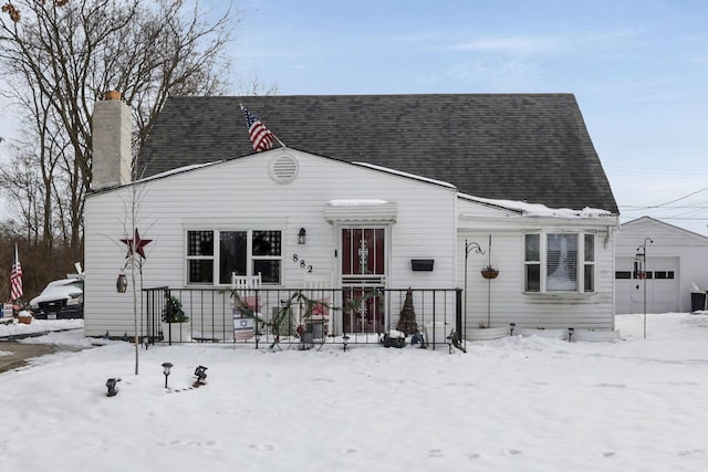 view of front of home featuring a shingled roof, a chimney, and an attached garage