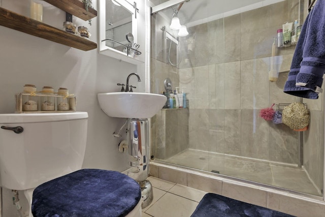 full bathroom featuring a stall shower, tile patterned flooring, and toilet