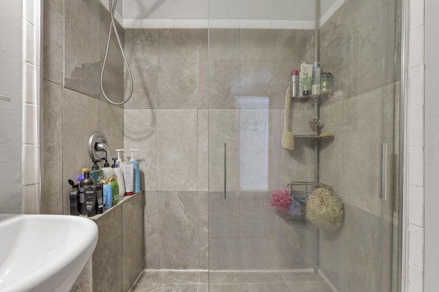 bathroom featuring a sink and a shower stall