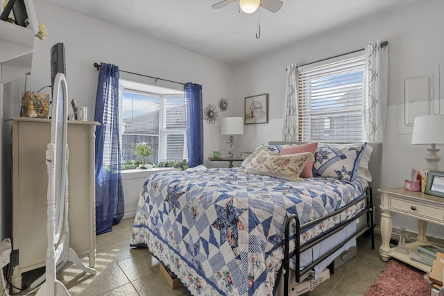 bedroom featuring multiple windows, ceiling fan, and tile patterned floors