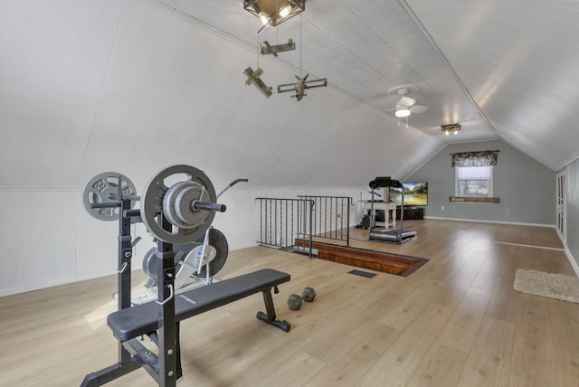 exercise room with lofted ceiling and wood finished floors