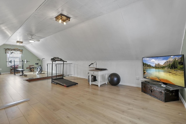 exercise area with vaulted ceiling and wood finished floors