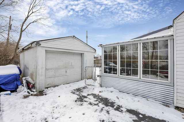 snow covered garage with a garage