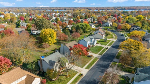 drone / aerial view featuring a water view and a residential view